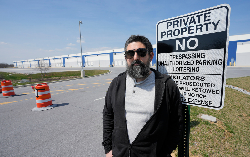 Activist Patrick Dattilio stands in front of a proposed ICE detention center in Williamsport, Md., Thursday, March 26, 2026. (AP Photo/Steve Helber)
