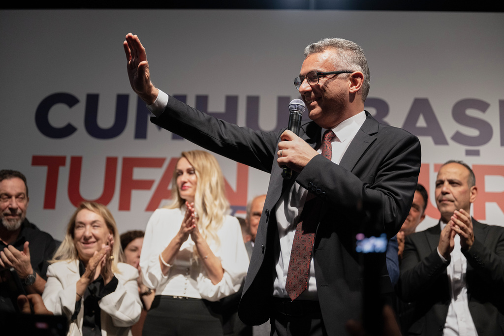 Turkish Cypriot newly elected leader Tufan Erhurman waves to supporters after winning the leadership election in the Turkish occupied northern part of the divided capital Nicosia, Cyprus, Sunday, Oct. 19, 2025. (AP Photo/Nedim Enginsoy)