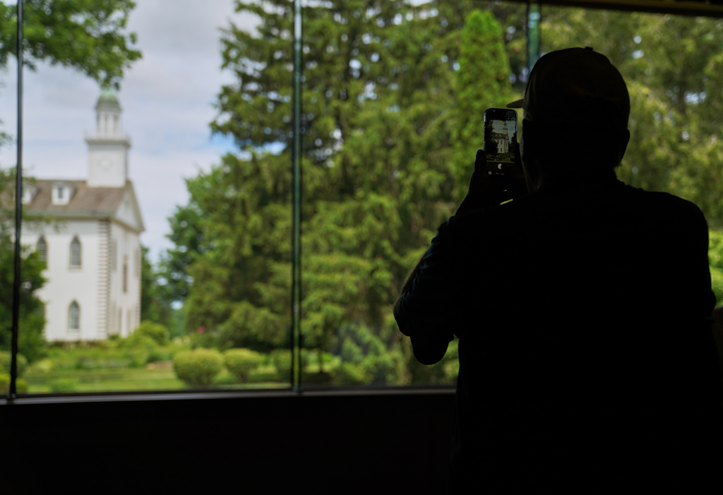A visitor takes a photo of the Kirtland temple, a nearly two-century old sanctuary considered the first temple in the movement Joseph Smith founded, on Wednesday, June 15, 2026, in Kirtland, Ohio. (AP Photo/Jessie Wardarski)