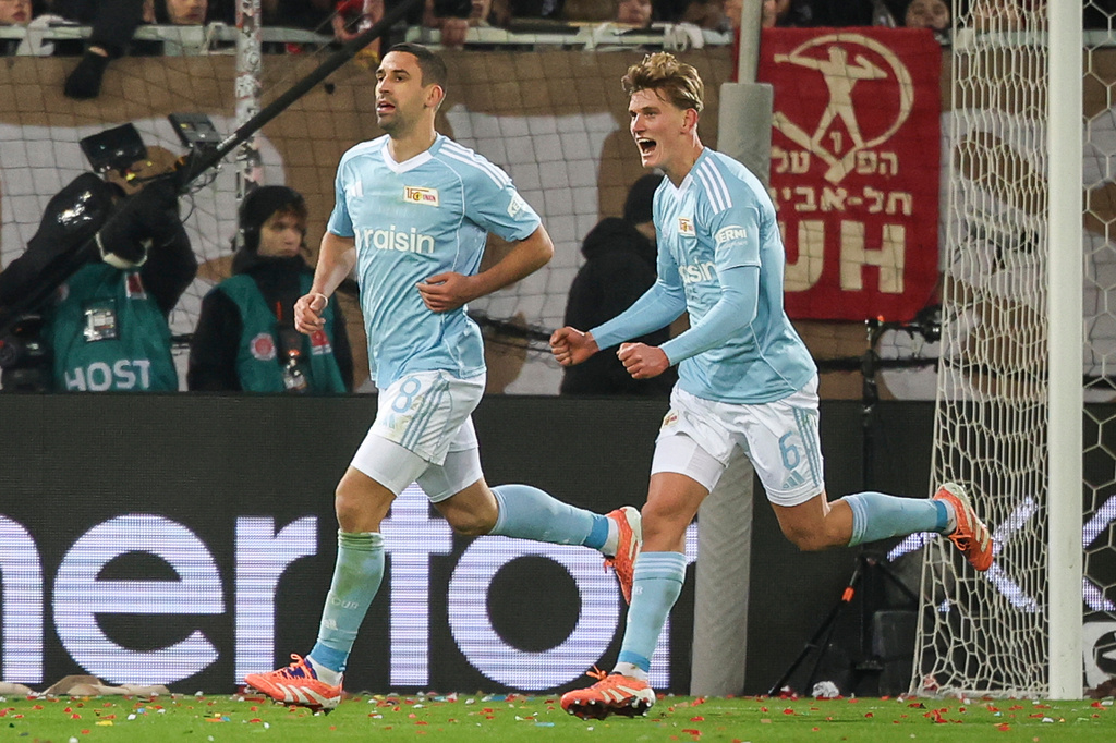 Union's Rani Khedira, left, after scoring the opening goal during the German Bundesliga Soccer match between 1. FC St. Pauli and 1. FC Union Berlin in Hamburg, Germany, Sunday, Nov. 23, 2025. (Christian Charisius/dpa via AP)
