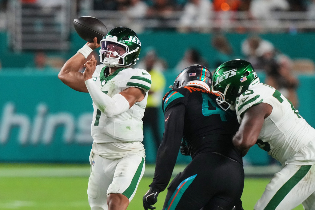 New York Jets quarterback Justin Fields (7) throws a pass under pressure from Miami Dolphins linebacker Chop Robinson (44) in the second half of an NFL football game, Monday, Sept. 29, 2025, in Miami Gardens, Fla. (AP Photo/Marta Lavandier)