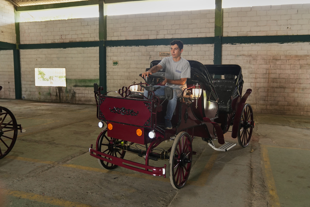 Engineer David Zuñiga tests an electric carriage at a warehouse in Cartagena, Colombia, Friday, Dec. 12, 2025. (AP Photo/Manuel Rueda)