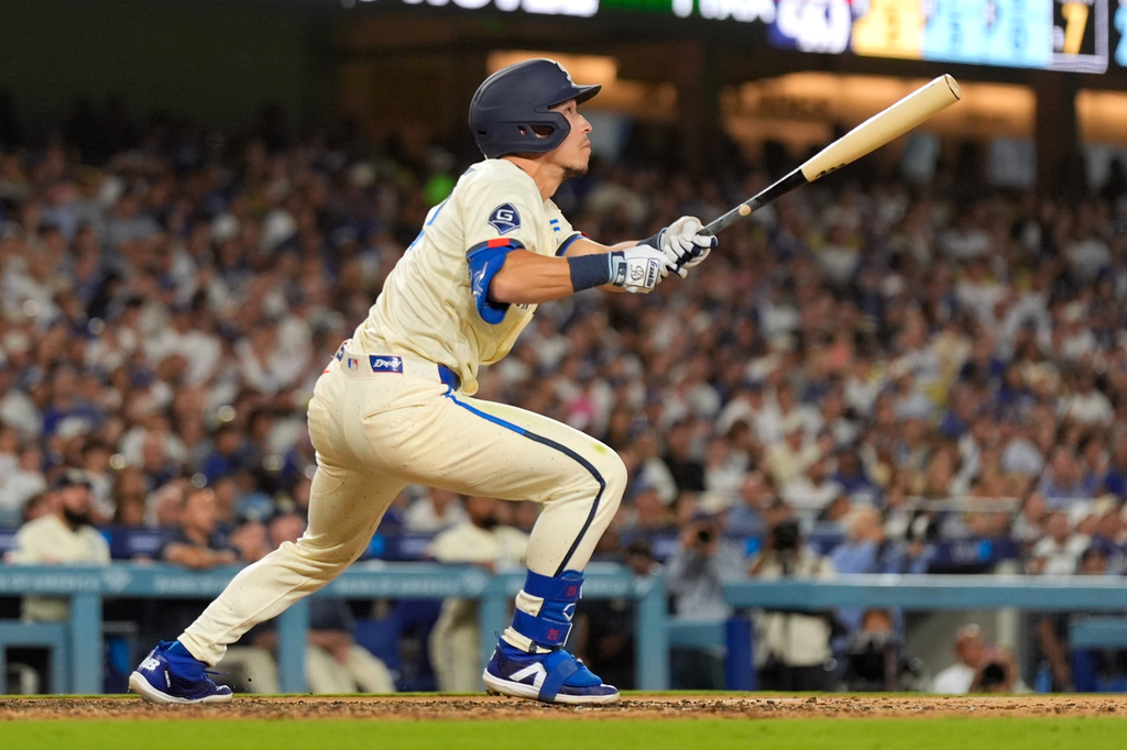 Los Angeles Dodgers' Tommy Edman heads to first for a three-run home run during the seventh inning of a baseball game against the Washington Nationals, Saturday, Sept. 5, 2026, in Los Angeles. (AP Photo/Mark J. Terrill)