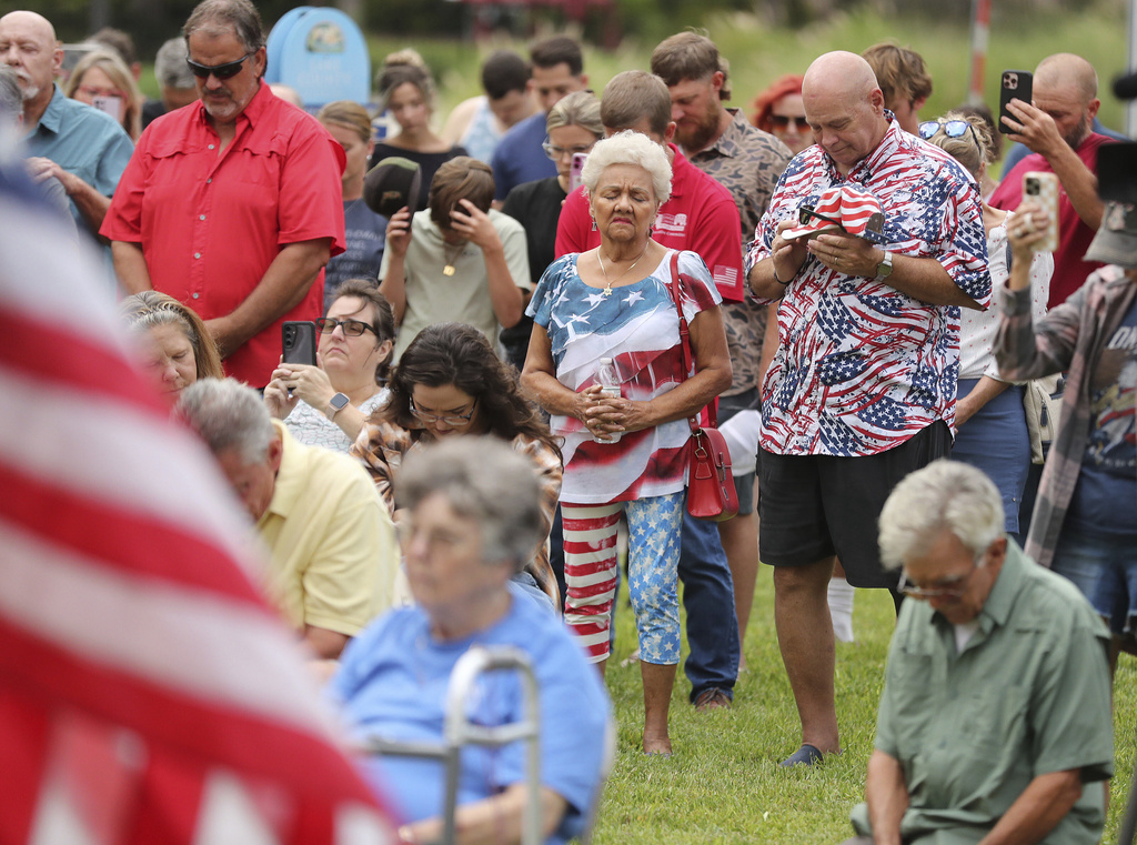 Attendees pray during a prayer vigil for Charlie Kirk at the Historic Lake County Courthouse in Tavares, Fla., Thursday, Sept. 11, 2025. (Stephen M. Dowell/Orlando Sentinel via AP)