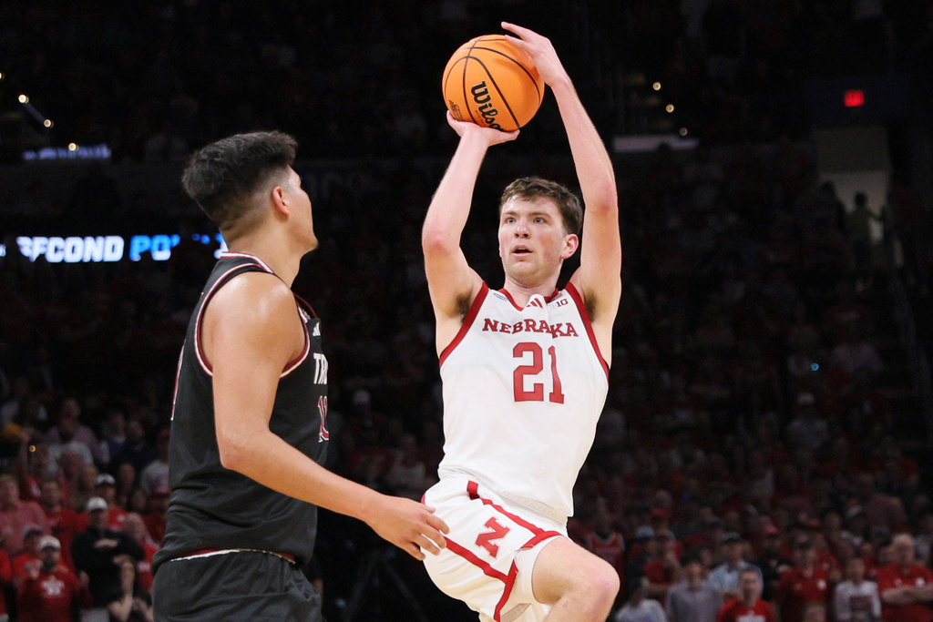 Nebraska forward Pryce Sandfort (21) looks to shoot over Troy forward Victor Valdes, left, during the first half in the first round of the NCAA college basketball tournament, Thursday, March 19, 2026, in Oklahoma City. (AP Photo/Nate Billings)
