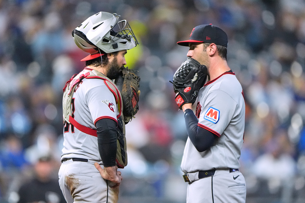 Cleveland Guardians catcher Austin Hedges, left, and starting pitcher Gavin Williams meet on the mound during the fourth inning of a baseball game against the Kansas City Royals, Friday, Sept. 25, 2026, in Kansas City, Mo. (AP Photo/Charlie Riedel)
