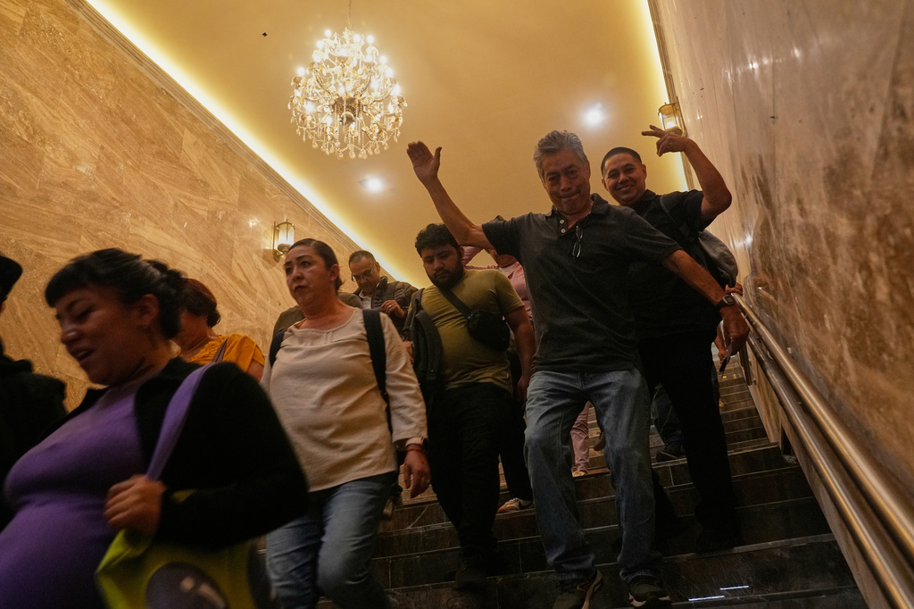 People walk through a subway station that has new lighting, part of preparations for hosting the World Cup soccer tournament in Mexico City, Wednesday, June 10, 2026. (AP Photo/Marco Ugarte)