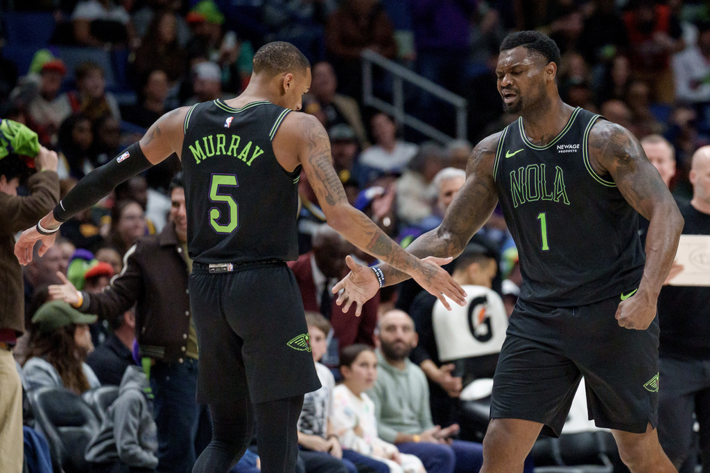 New Orleans Pelicans forward Zion Williamson (1) reacts next to guard Dejounte Murray (5) during the first half of an NBA basketball game against the Golden State Warriors in New Orleans, Tuesday, Feb. 24, 2026. (AP Photo/Matthew Hinton)