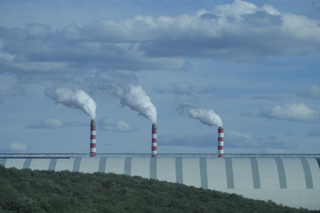 Chimneys for a super low emission coal fired plant are seen near the Huaneng Yimin open-pit coal mine in Hulunbuir in northern China's Inner Mongolia province China, Monday, Sept. 15, 2025. (AP Photo/Ng Han Guan)