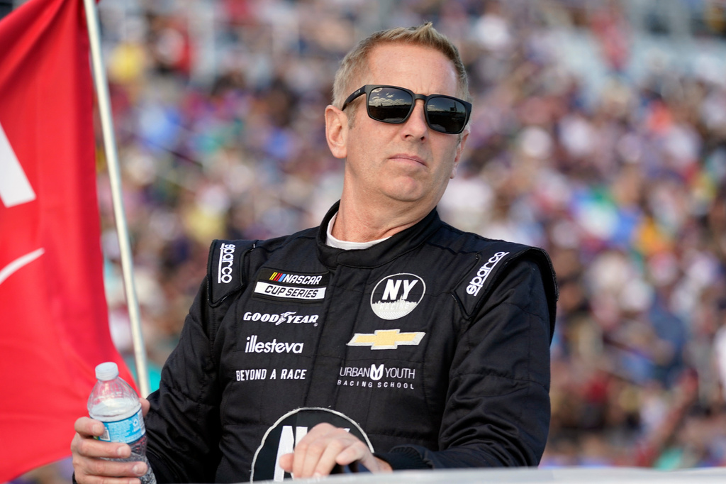 FILE - Greg Biffle looks on during driver introductions before the NASCAR Daytona 500 auto race at Daytona International Speedway, in Daytona Beach, Fla., Feb. 20, 2022. (AP Photo/John Raoux, File)