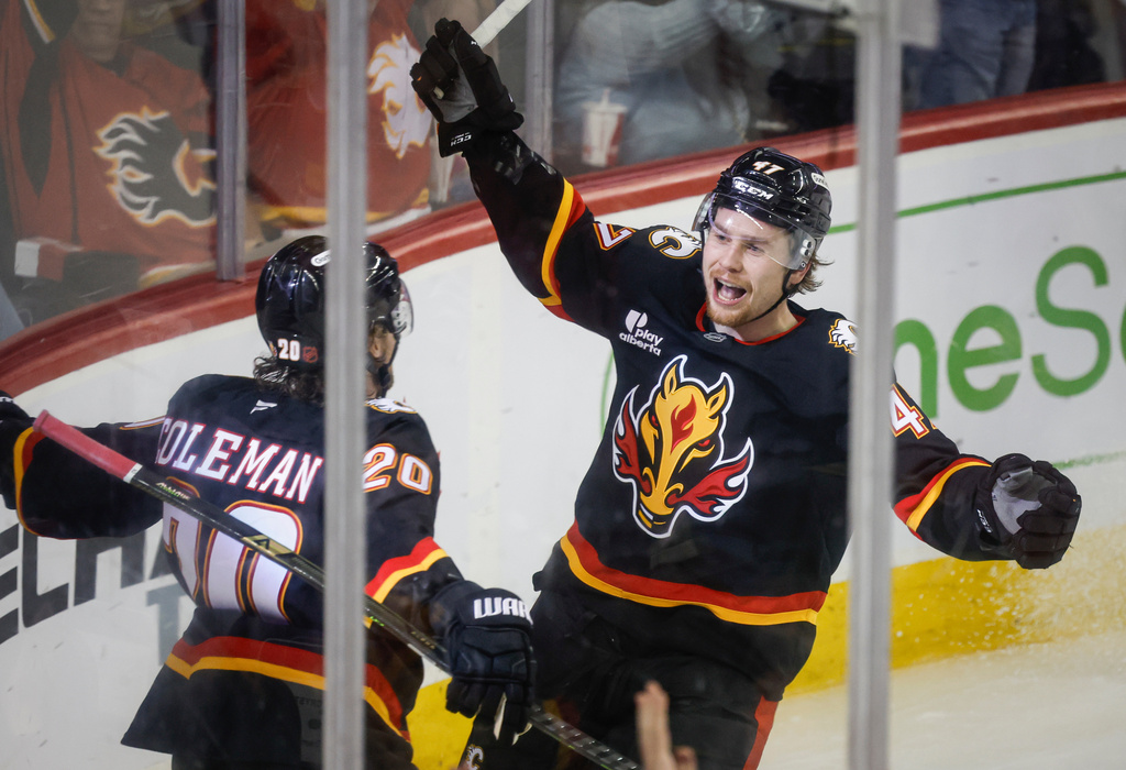 Calgary Flames' Connor Zary, right, celebrates his goal with teammate Blake Coleman during third period NHL hockey action against the Minnesota Wild in Calgary on Thursday, Dec. 4, 2025. (Jeff McIntosh/The Canadian Press via AP)