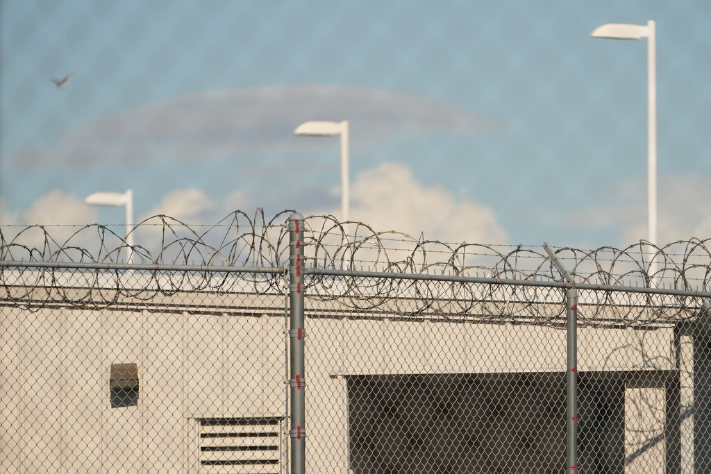 Barbed wire is seen through chain link fences at the Northwest U.S. Immigration and Customs Enforcement Processing Center, Aug. 13, 2025, in Tacoma, Wash. (AP Photo/Lindsey Wasson)