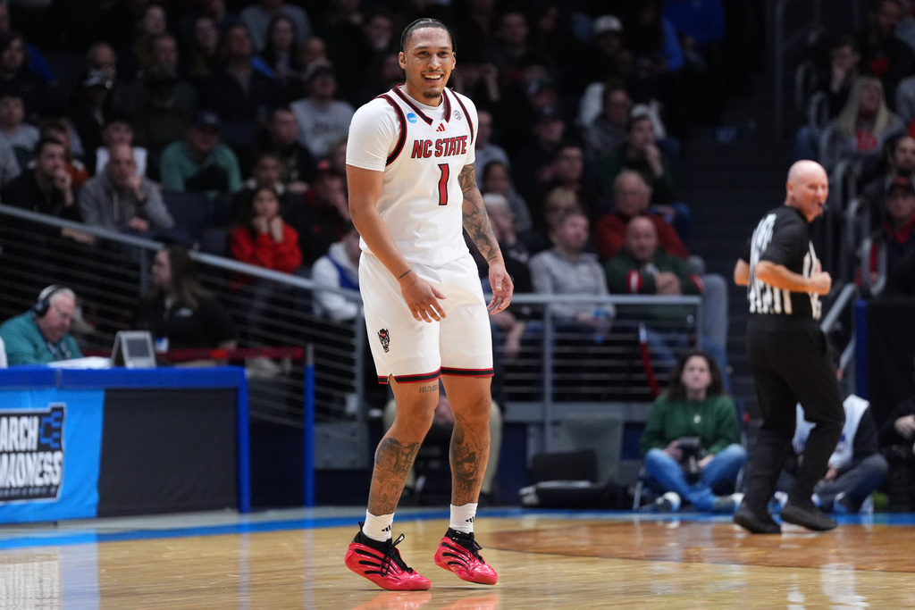 North Carolina State forward Darrion Williams (1) smiles after scoring a 3-point basket during the first half in a First Four college basketball game in the NCAA Tournament against Texas, Tuesday, March 17, 2026, in Dayton, Ohio. (AP Photo/Kareem Elgazzar)