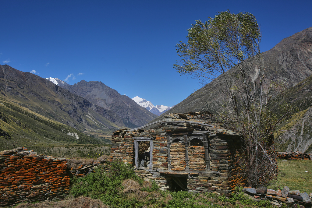 Lichen grows on the stone walls of a structure in the abandoned village of Martoli, in the northern Indian Himalayan state of Uttarakhand, on Oct. 4, 2025. (AP Photo/Satish Sharma)