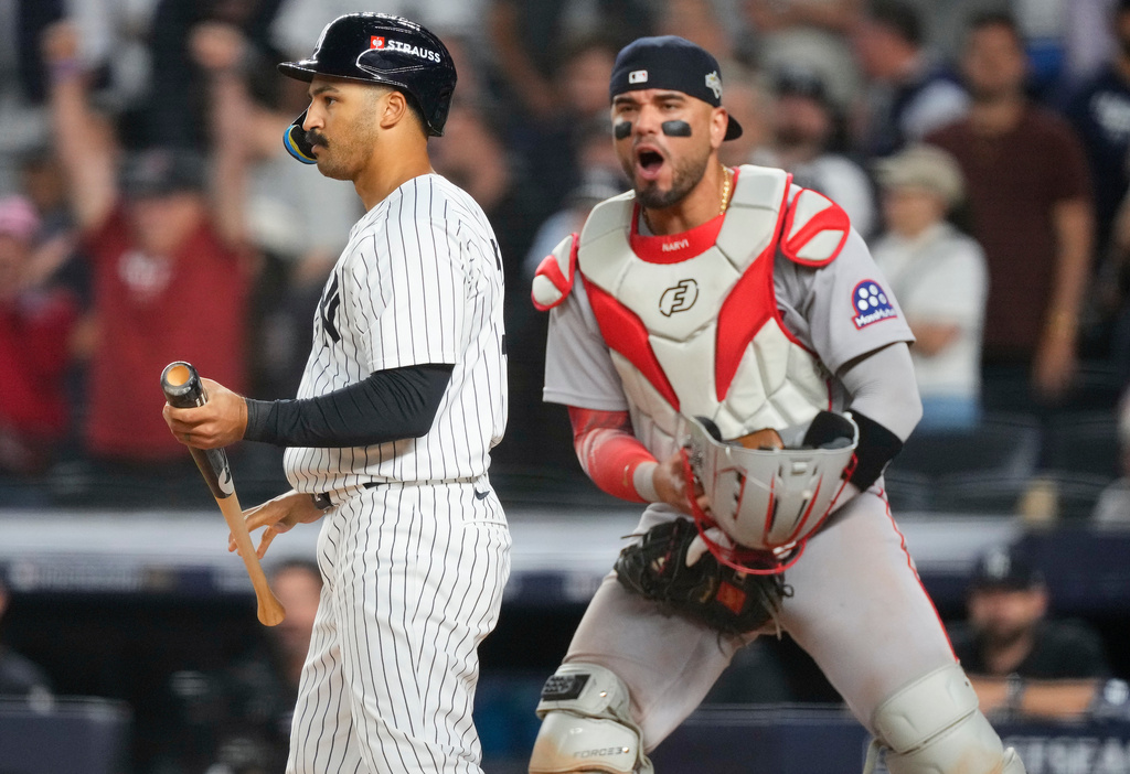 New York Yankees Trent Grisham, left, and Boston Red Sox catcher Carlos Narváez react after Grisham struck out with the bases loaded during the ninth inning to end Game 1 of an American League wild-card baseball playoff series, Tuesday, Sept. 30, 2025, in New York. (AP Photo/Yuki Iwamura)