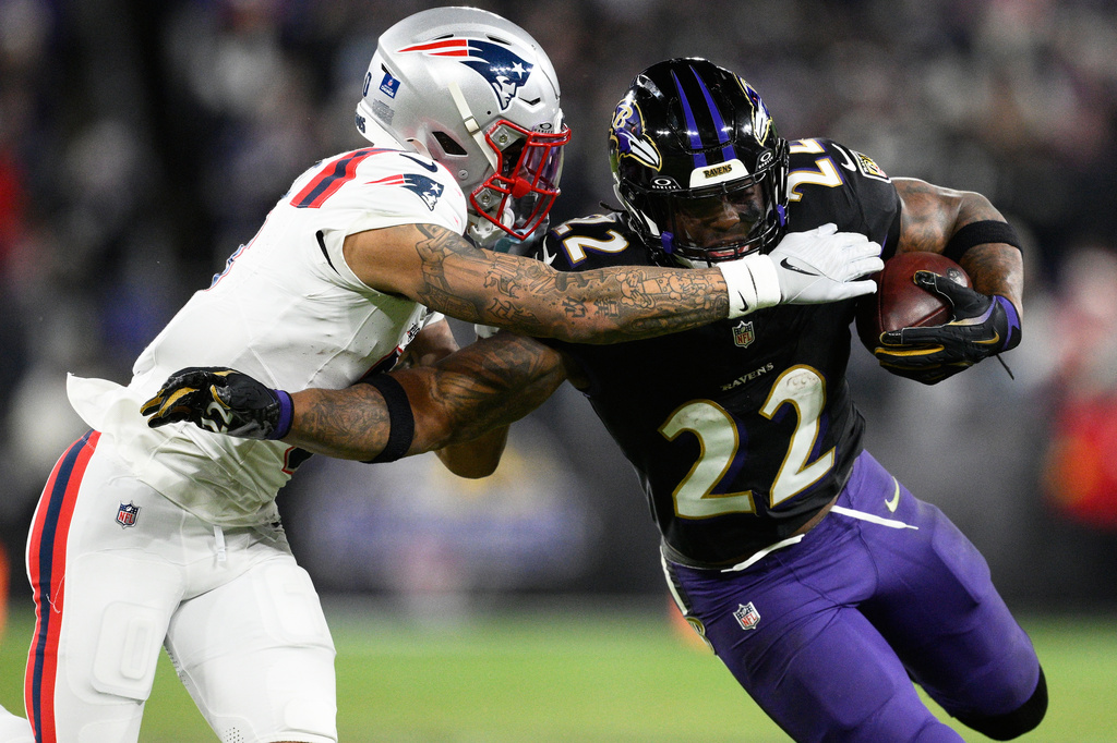 FILE - Baltimore Ravens running back Derrick Henry (22) runs against New England Patriots cornerback Christian Gonzalez during the second half of an NFL football game, Dec. 21, 2025, in Baltimore. (AP Photo/Nick Wass, File)