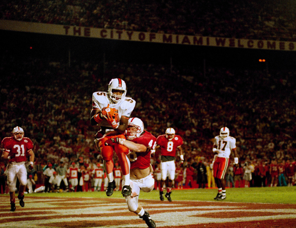 FILE -Miami wide receiver Kevin Williams (5) cradles a Gino Torretta pass in the end zone for a touchdown during first quarter action in the Orange Bowl in Miami Jan. 1, 1992. (AP Photo/Kathy Willens, File)