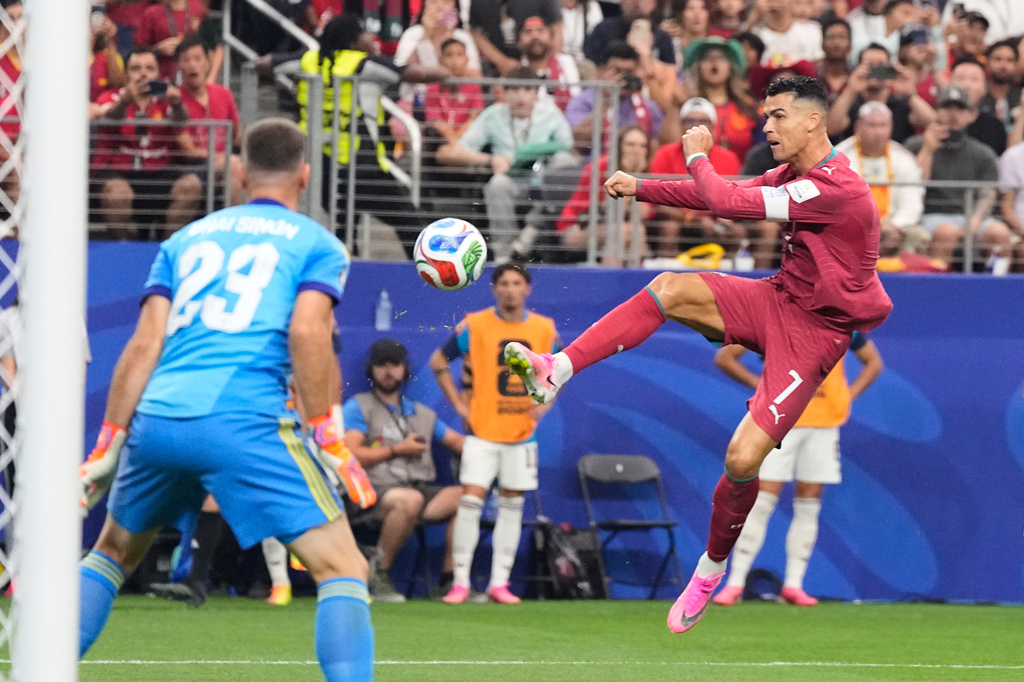 Portugal's Cristiano Ronaldo (7) shoots against Spain goalkeeper Unai Simon (23) during the World Cup round of 16 soccer match in Arlington, Texas, near Dallas, Monday, July 6, 2026. (AP Photo/Ashley Landis)