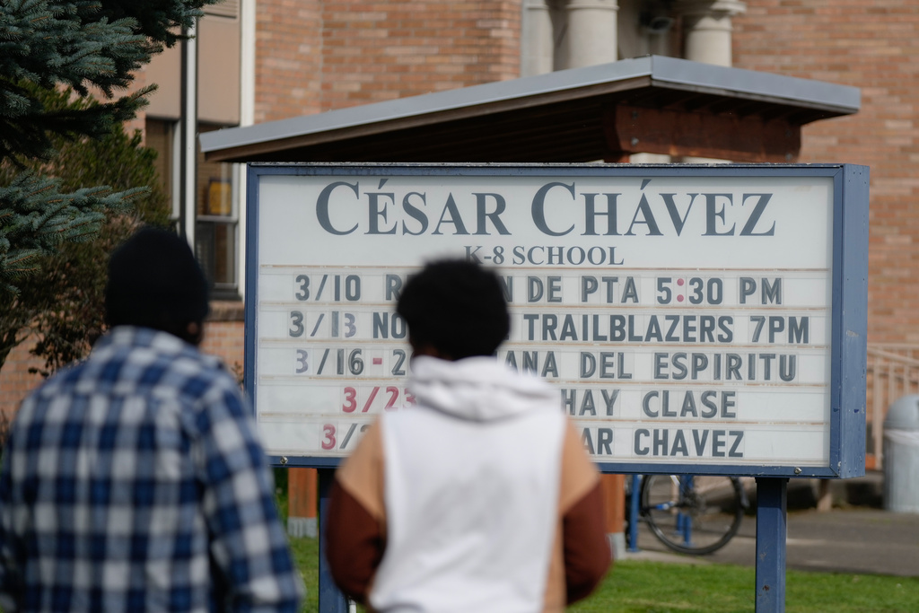 A sign for Cesar Chavez School is seen on Wednesday, March 18, 2026, in Portland, Ore. (AP Photo/Jenny Kane)
