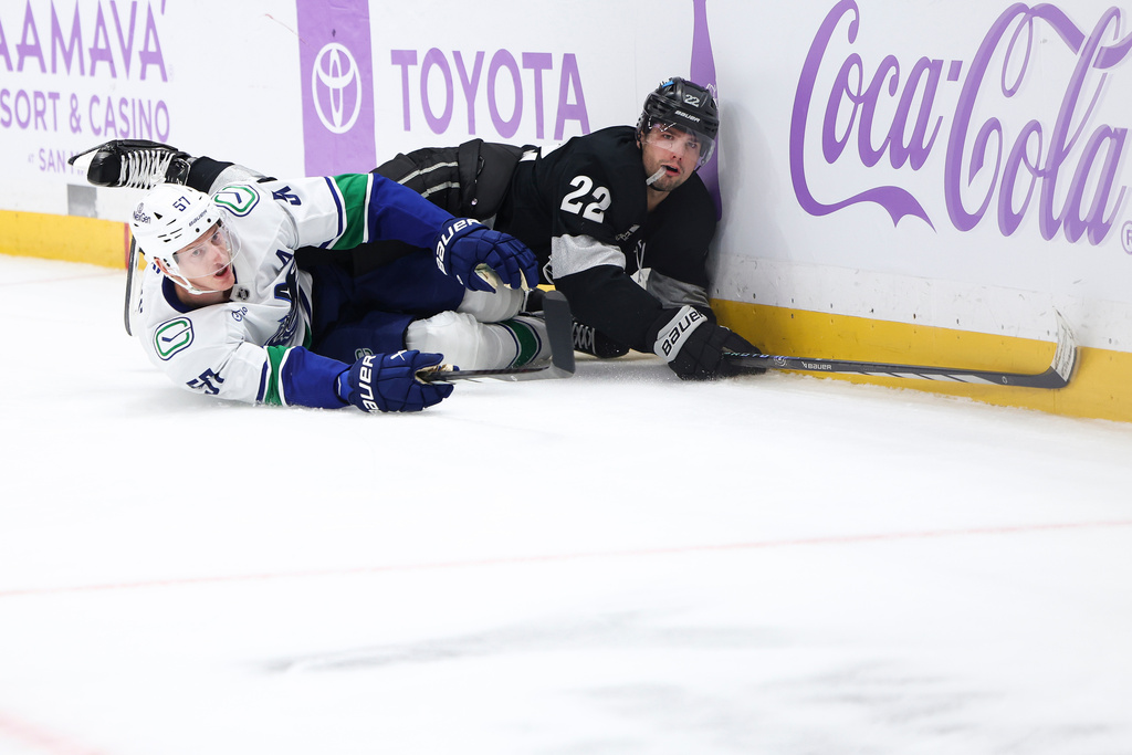 Los Angeles Kings left wing Kevin Fiala (22) and Vancouver Canucks defenseman Tyler Myers (57) look on from the ice during the second period of an NHL hockey game, Saturday, Nov. 29, 2025, in Los Angeles. (AP Photo/Jessie Alcheh)
