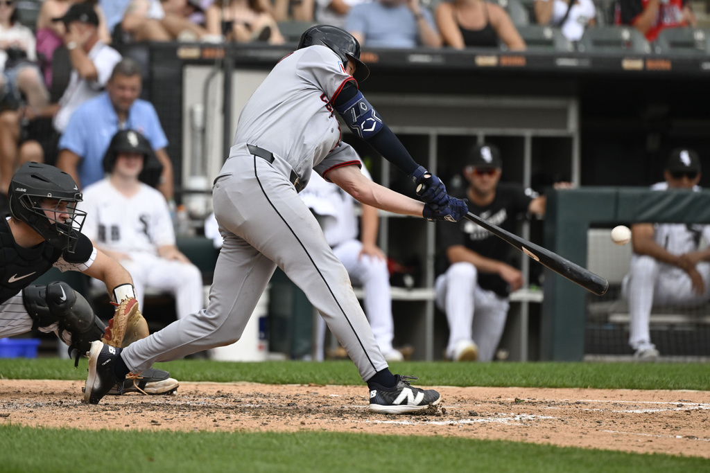 Cleveland Guardians' Kyle Manzardo hits a home run during the seventh inning of a baseball game against the Chicago White Sox, Sunday, Aug. 10, 2025, in Chicago. (AP Photo/Matt Marton)