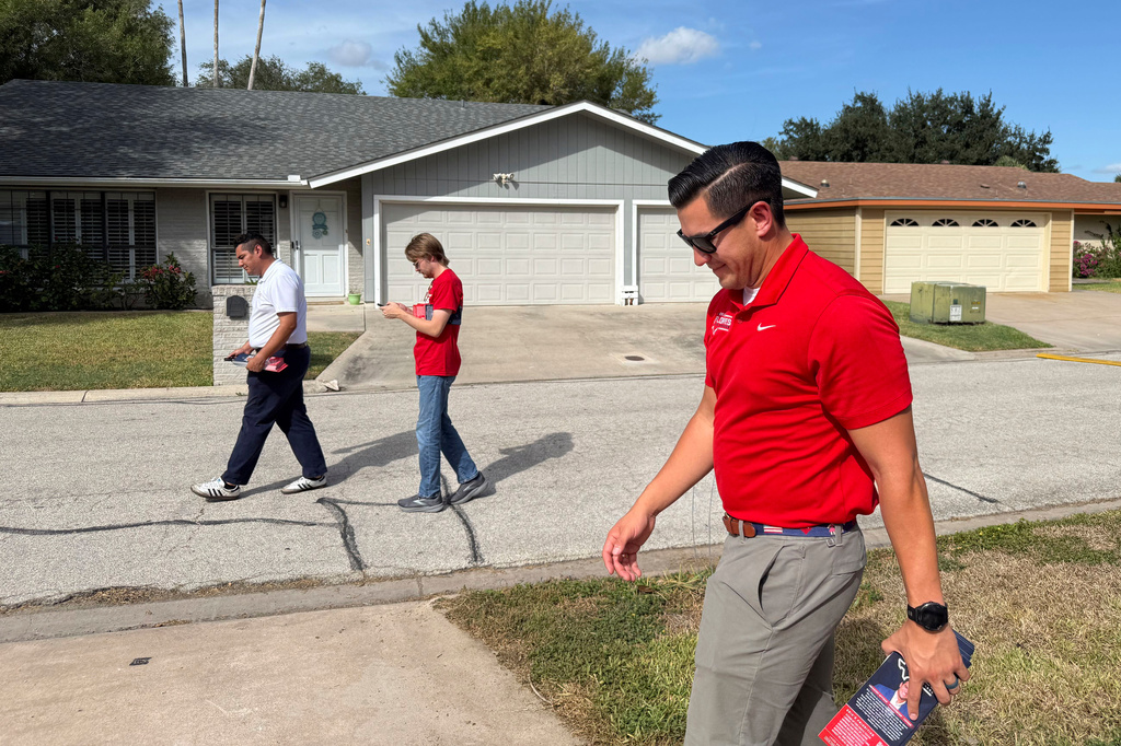 This photo taken with a smartphone shows Republican U.S. House candidate Eric Flores door knocks on Sunday, Sept. 18, 2026, in Harlingen, Texas. (AP Photo/Jesse Bedayn)