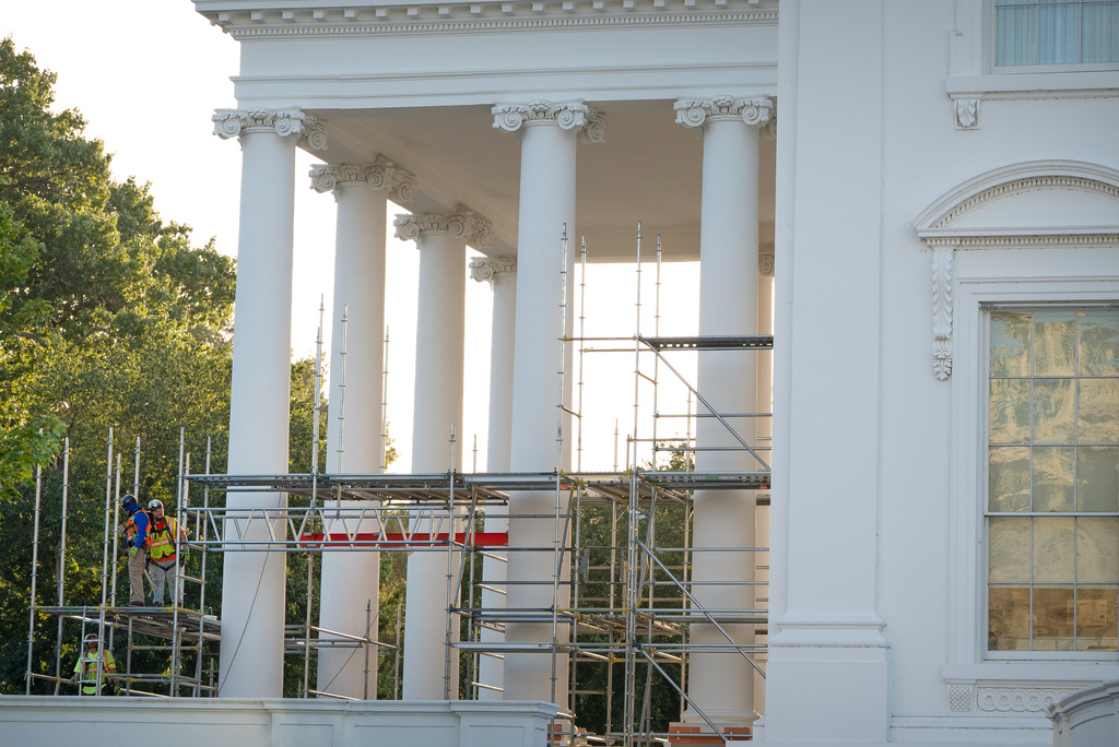 Workers remove scaffolding from columns at the North Portico of the White House, Tuesday, Sept. 8, 2026, in Washington. (AP Photo/Mark Schiefelbein)