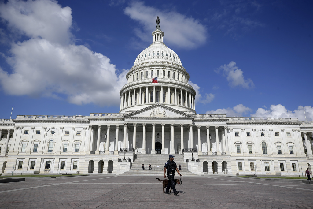 A U.S. Capitol Police officer walks in front of the U.S. Capitol, Friday, Aug. 22, 2025, in Washington. (AP Photo/Rahmat Gul)