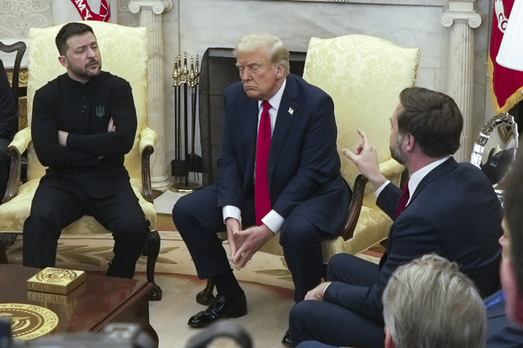 FILE - U.S. Vice President JD Vance, right, speaks with Ukrainian President Volodymyr Zelenskyy, left, as President Donald Trump listens, in the Oval Office at the White House on Feb. 28, 2025, in Washington. (AP Photo/ Mystyslav Chernov, File)