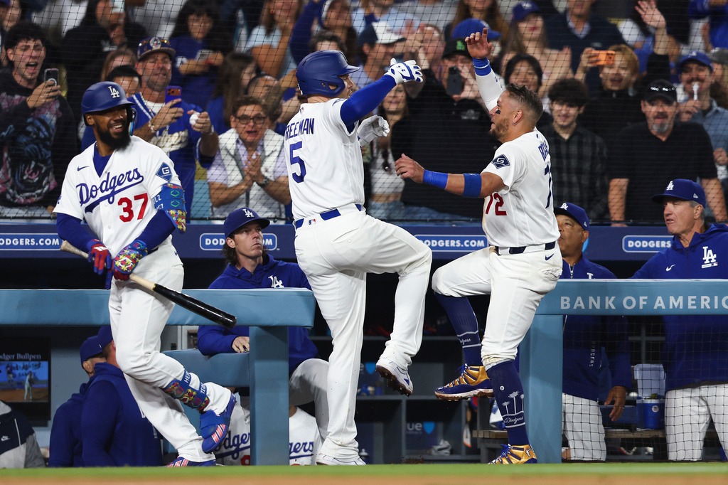 Los Angeles Dodgers' Freddie Freeman (5) and Miguel Rojas, right, celebrate after Freddie Freeman hits a home run as Teoscar Hernández (37) watches during the sixth inning of a baseball game against the Atlanta Braves, Friday, May 8, 2026, in Los Angeles. (AP Photo/Jessie Alcheh)
