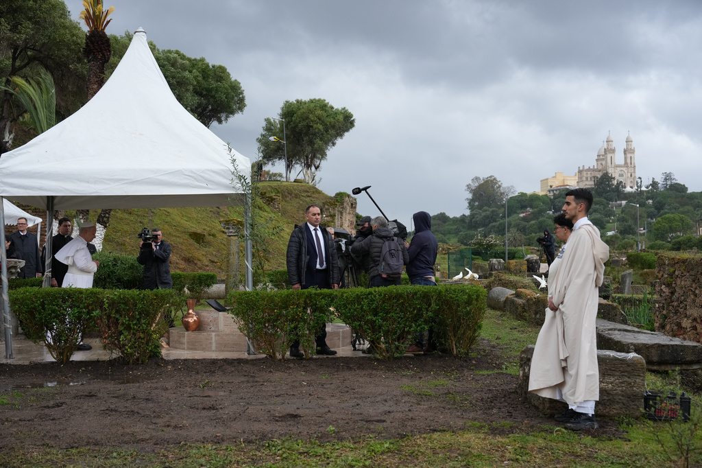Pope Leo XIV, left, prays as he visits the archaeological site of Hippo, in Annaba, Algeria, Tuesday, April 14, 2026, on the second day of an 11-day apostolic journey to Africa. (AP Photo/Andrew Medichini)
