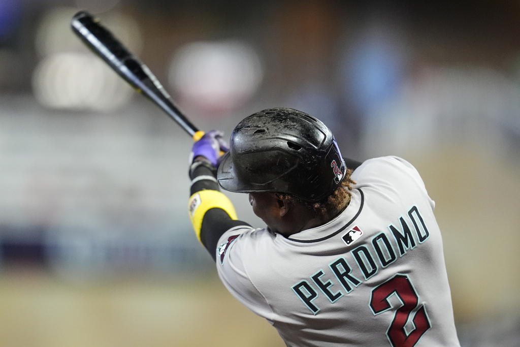 Arizona Diamondbacks shortstop Geraldo Perdomo (2) hits a two-run home run against the Minnesota Twins in the seventh inning of a baseball game, Friday, Sept. 12, 2025, in Minneapolis. (AP Photo/Mike Stewart)