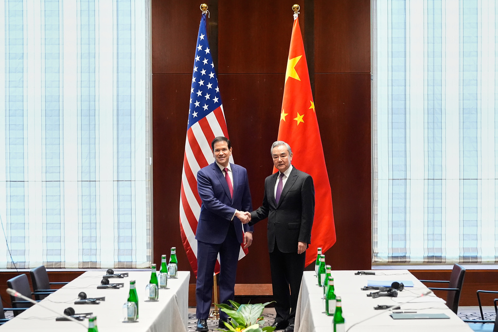 Secretary of State Marco Rubio shakes hands with China's Foreign Minister Wang Yi in Munich, Germany, Friday, Feb. 13, 2026, at the beginning of a meeting on the sidelines of the Munich Security Conference. (AP Photo/Alex Brandon, Pool)