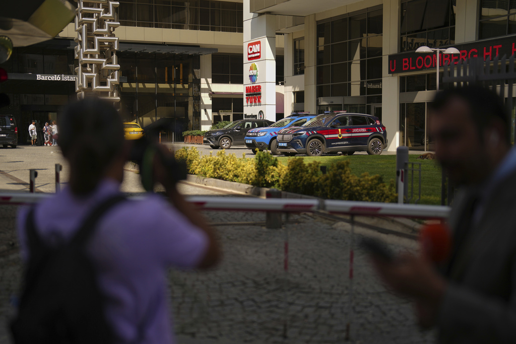 Journalists work outside Haberturk and ShowTv news broadcasters offices, both part of Turkish Can Holding media group, in Istanbul, Turkey, Thursday, Sept. 11, 2025. (AP Photo/Francisco Seco)