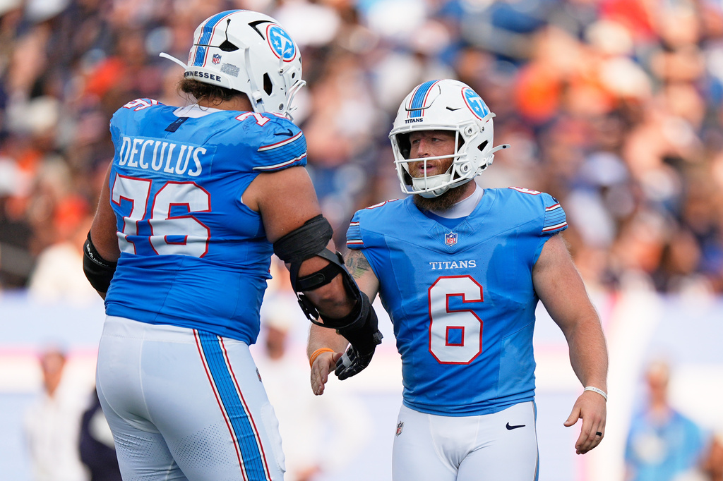 Tennessee Titans offensive tackle Austin Deculus, left, congratulates kicker Joey Slye on a field goal kick during the first half of a preseason NFL football game against the Chicago Bears, Saturday, Aug. 29, 2026, in Nashville, Tenn. (AP Photo/George Walker IV)