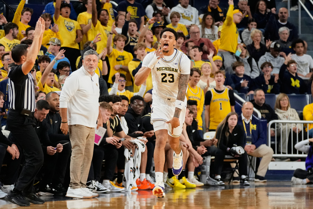 Michigan forward Morez Johnson Jr. reacts after a three-point basket during the first half of an NCAA college basketball game against Oakland, Monday, Nov. 3, 2025, in Ann Arbor, Mich. (AP Photo/Ryan Sun)