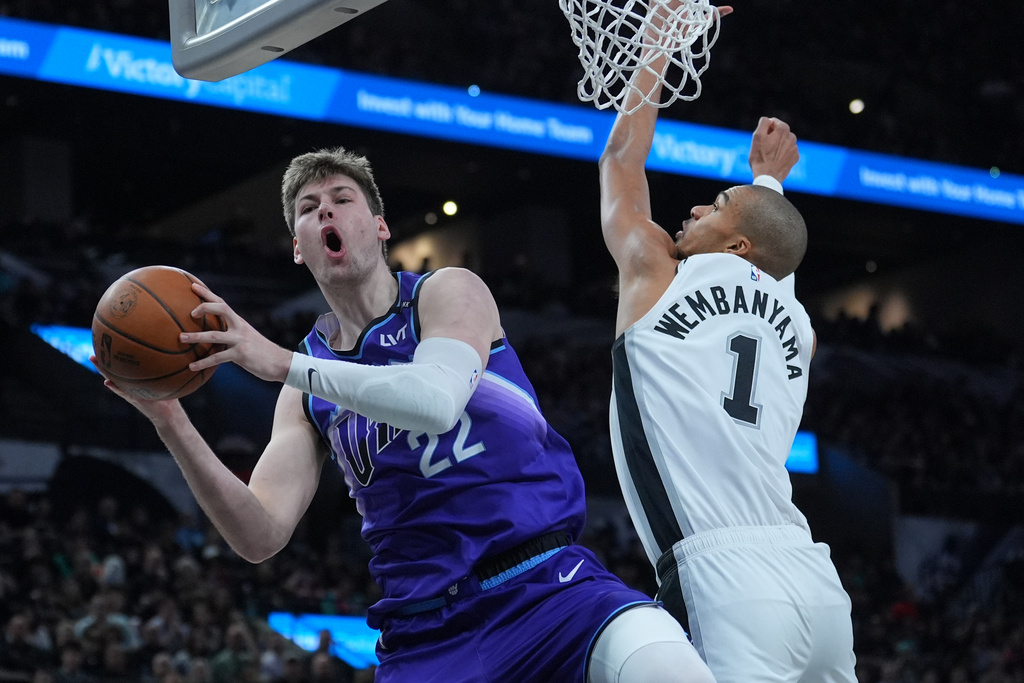 Utah Jazz forward Kyle Filipowski (22) is fouled by San Antonio Spurs forward Victor Wembanyama (1) during the second half of an NBA basketball game in San Antonio, Monday, Jan. 19, 2026. (AP Photo/Eric Gay)