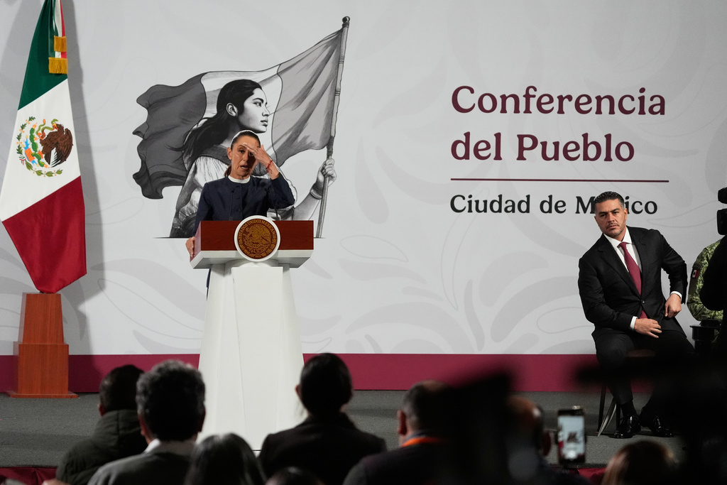 Mexican President Claudia Sheinbaum, left, and Secretary of Security and Citizen Protection Omar García Harfuch give a morning press conference at the National Palace in Mexico City, Monday, Nov. 3, 2025. (AP Photo/Marco Ugarte)