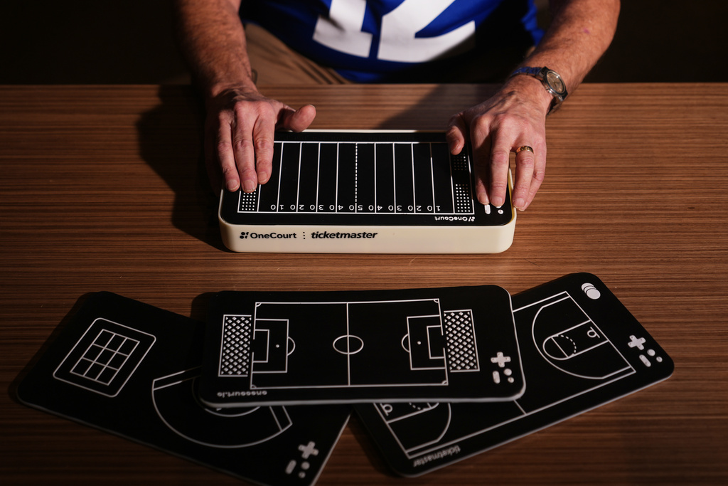 Clark Roberts, a blind Seattle Seahawks fan, uses a OneCourt tablet, a tactile device that translates gameplay into trackable vibrations along with real-time audio, at the T-Mobile Innovation Hub Tuesday, Jan. 27, 2026, in Bellevue, Wash. (AP Photo/Lindsey Wasson)