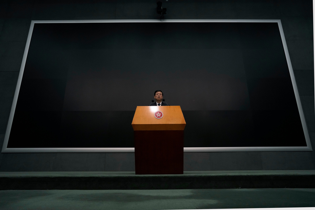 Hong Kong Chief Executive John Lee speaks during a press conference with a darken screen in the aftermath of a deadly fire in Hong Kong on Tuesday, Dec. 2, 2025. (AP Photo/Ng Han Guan)
