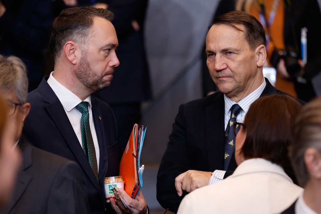 Belgium's Foreign Minister Maxime Prevot, left, speaks with Poland's Foreign Minister Radoslaw Sikorski during a meeting of the North Atlantic Council in Foreign Ministers Session at NATO headquarters in Brussels, Wednesday, Dec. 3, 2025. (AP Photo/Geert Vanden Wijngaert)