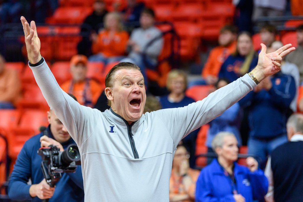 Illinois head coach Brad Underwood reacts to the return of the Orange Krush student section prior to the first half of an NCAA college basketball game against Maryland Wednesday, Jan. 21, 2026, in Champaign, Ill. (AP Photo/Craig Pessman)