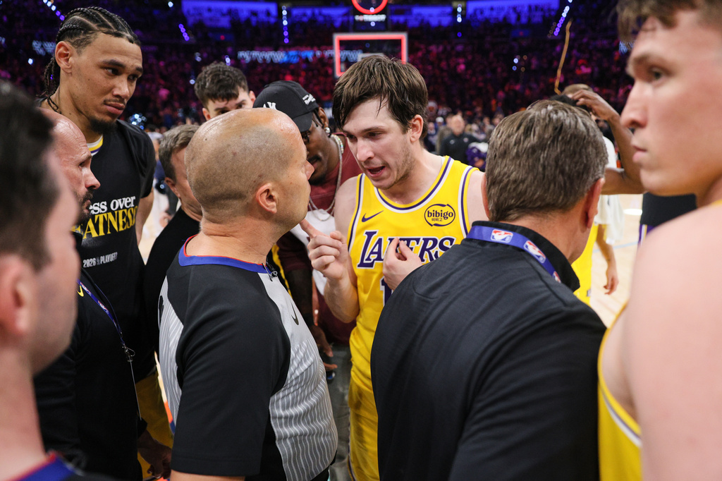 Los Angeles Lakers' Austin Reaves, center right, talks with referee John Goble, center, left, after the team's loss in Game 2 in a second-round NBA basketball playoffs series against the Oklahoma City Thunder Thursday, May 7, 2026, in Oklahoma City. (AP Photo/Nate Billings)
