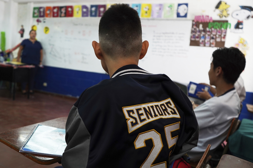 A student with freshly cut hair sits in class at a public school in San Salvador, El Salvador, Friday, Aug. 22, 2025. (AP Photo/Salvador Melendez)