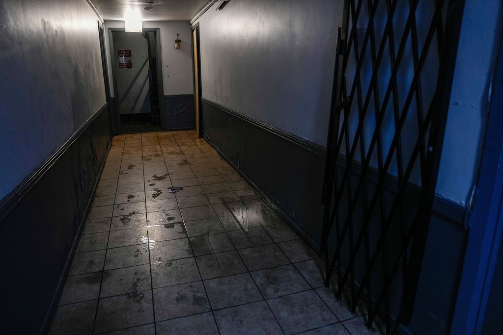 Water collects on the floor on Oct. 10, 2025, inside the building at 7500 South Shore Drive in Chicago, which was raided by federal agents on Sept. 30. (AP Photo/Erin Hooley)
