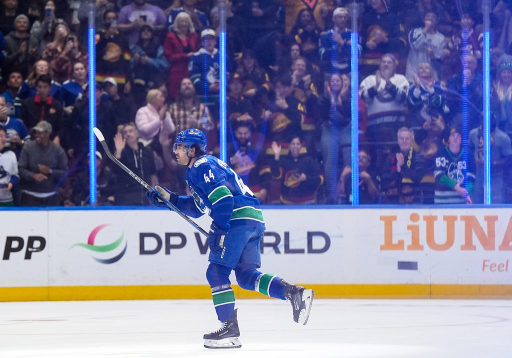 Vancouver Canucks' Kiefer Sherwood celebrates after his second goal against the St. Louis Blues, during the second period of an NHL hockey game in Vancouver, British Columbia, Monday, Oct. 13, 2025. (Darryl Dyck/The Canadian Press via AP)