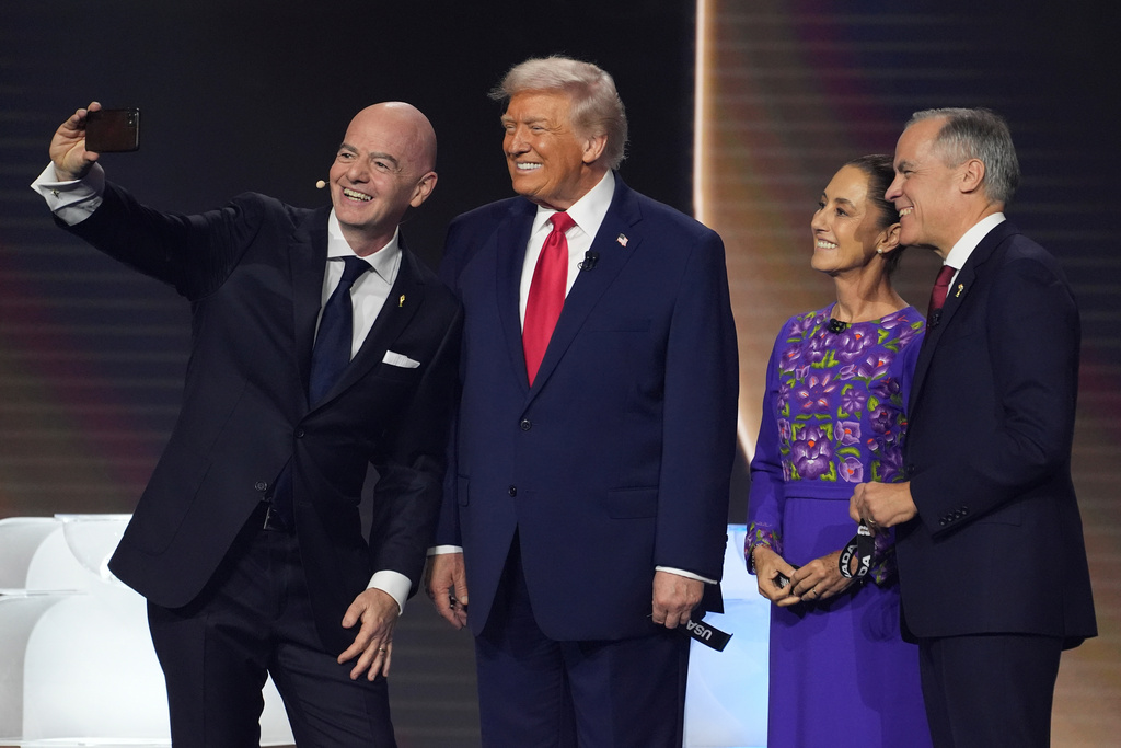 From l-r., FIFA President Gianni Infantino takes a selfie with President Donald Trump, Mexican President Claudia Sheinbaum, and Canadian Prime Minister Mark Carney during the draw for the 2026 soccer World Cup at the Kennedy Center in Washington, Friday, Dec. 5, 2025.(AP Photo/Evan Vucci)
