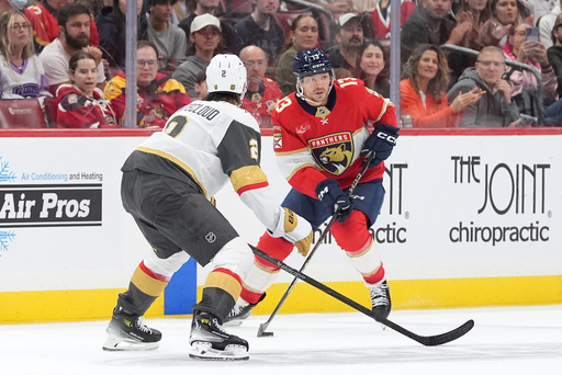 Florida Panthers center Sam Reinhart (13) controls the puck under pressure from Vegas Golden Knights defenseman Zach Whitecloud (2) during the second period of an NHL hockey game, Saturday, Oct. 25, 2025, in Sunrise, Fla. (AP Photo/Rebecca Blackwell) Florida Panthers center Sam Reinhart (13) controls the puck under pressure from Vegas Golden Knights defenseman Zach Whitecloud (2) during the second period of an NHL hockey game, Saturday, Oct. 25, 2025, in Sunrise, Fla. (AP Photo/Rebecca Blackwell)