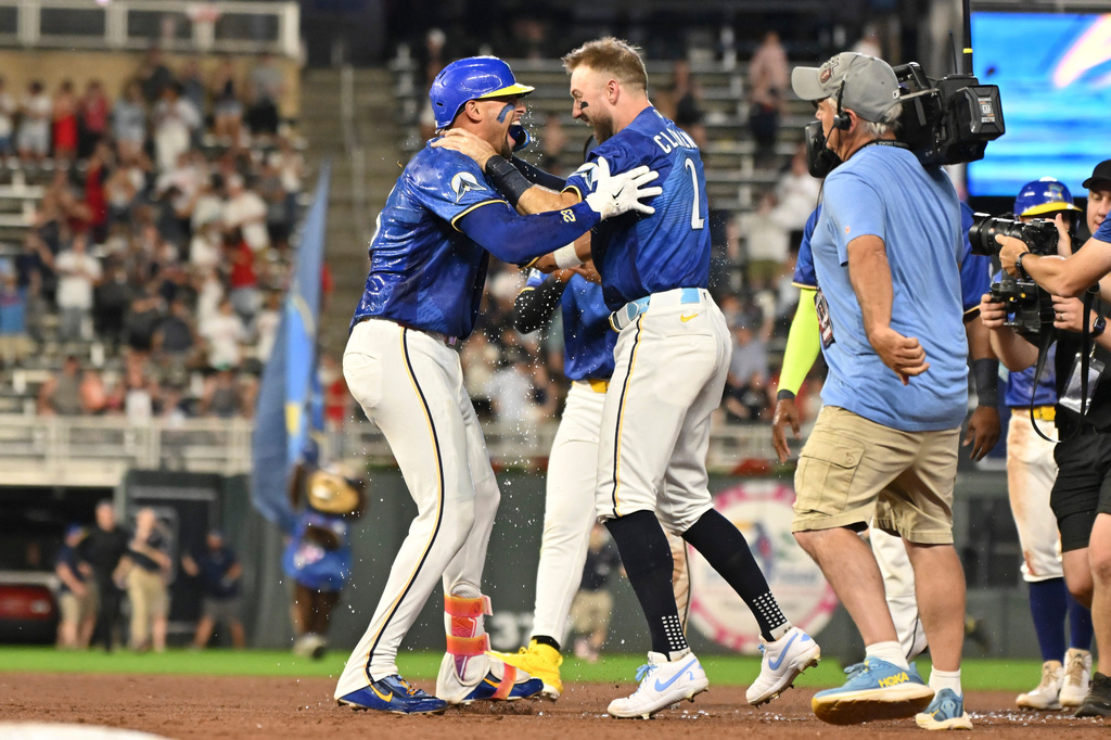 Minnesota Twins' Royce Lewis, left, celebrates with Kody Clemens (2) after hitting a walkoff single against the Colorado Rockies during the 10th inning of a baseball game Friday, June 26 2026, in Minneapolis. (AP Photo/Craig Lassig)