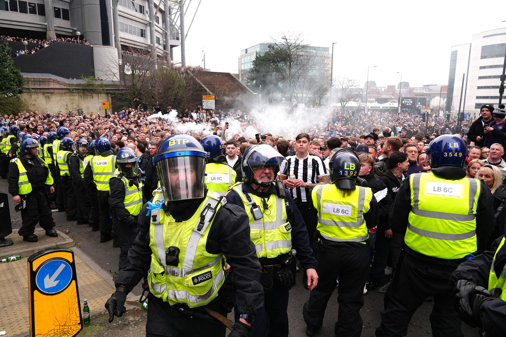 Police separate Newcastle United and Sunderland fans ahead of the Premier League match between Newcastle and Sunderland outside St James' Park, Newcastle upon Tyne, England, Sunday March 22, 2026. (Owen Humphreys/PA via AP)